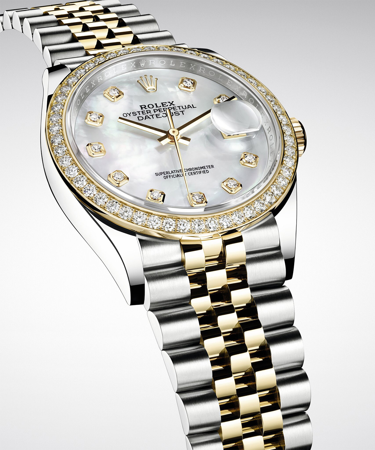 A luxury Rolex wristwatch with a silver and rose gold bracelet, intricate diamond detailing, and a round, embossed dial face shown in a close-up view.
